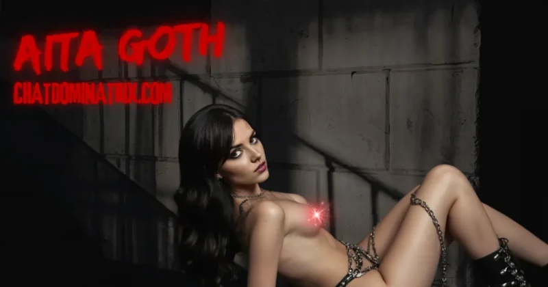 Aita Goth reclining against a dark industrial wall, wearing chains and black leather boots, exuding sensual dominance and submission, symbolizing the allure of BDSM and kink exploration. Featured image for 'Kink Exploration' by Aita Goth on ChatDominatrix.com