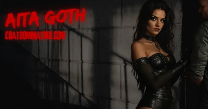 Aita Goth in a dark, industrial setting wearing a black leather corset and gloves, holding a leash attached to a submissive man, BDSM dominance and power play. Featured image for 'The Best BDSM Toys for Beginners: A Complete Guide to Getting Started' on ChatDominatrix.com.