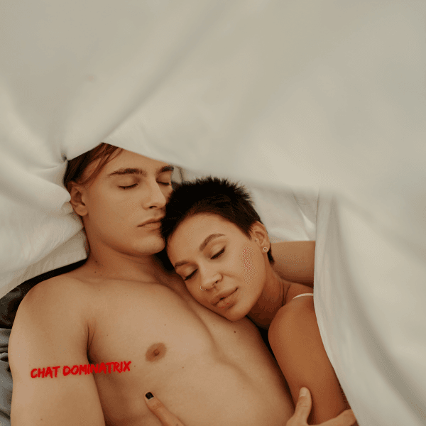 Couple cuddling under soft sheets – the importance of intimacy and connection after an intense BDSM experience