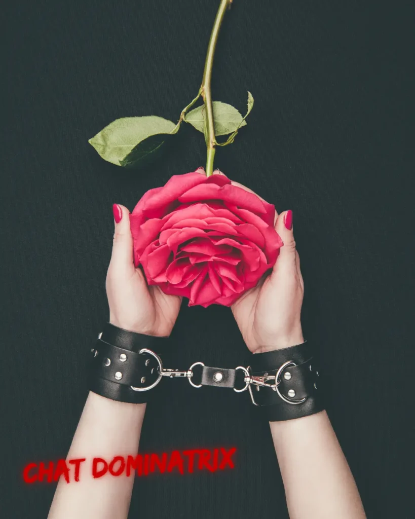 Submissive hands in leather cuffs holding a rose, symbolizing BDSM service submission, obedience, and the emotional fulfillment of being useful in power exchange