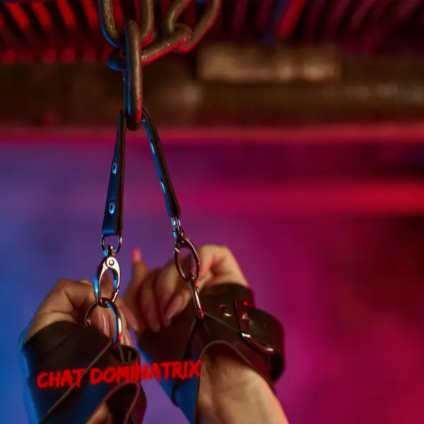 Close-up of suspended hands in leather cuffs, setting the scene for high-voltage dominance and submission