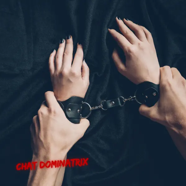 A close-up of a submissive’s wrists locked in black leather handcuffs, restrained against a dark background. The firm grip of the dominant's hands emphasizes control, discipline, and the structured restraint of handcuffs in BDSM play. Unlike rope bondage, handcuffs offer quick immobilization, adding an element of strict authority and power exchange.