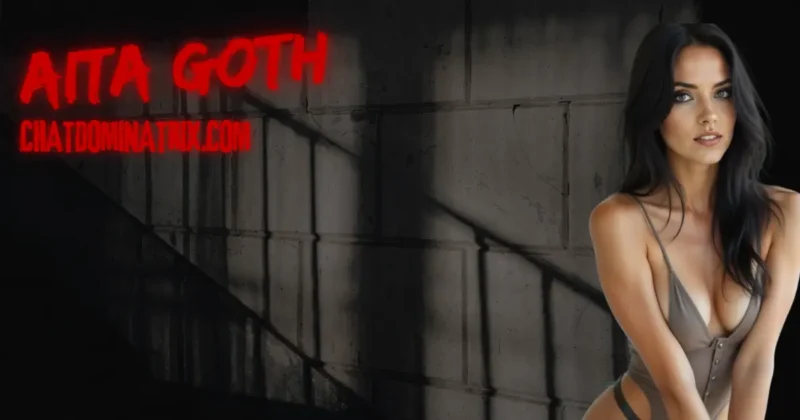 Dominatrix Aita Goth in revealing bodysuit beside dungeon wall, representing keyholding authority and psychological power in male chastity submission